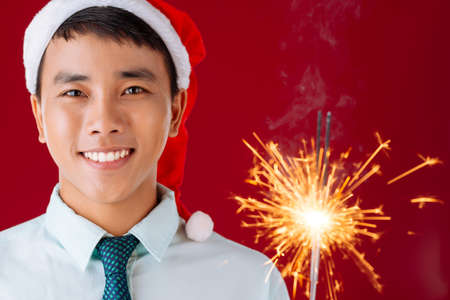 Close-up of Vietnamese man with Bengal light looking at the cameraの写真素材