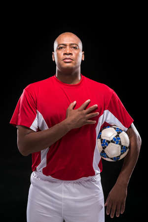 Soccer player listening to national anthemの写真素材
