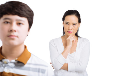 Portrait of mother displeased with her sonの写真素材