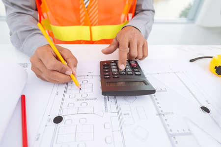 Cropped image of architect doing calculationsの写真素材