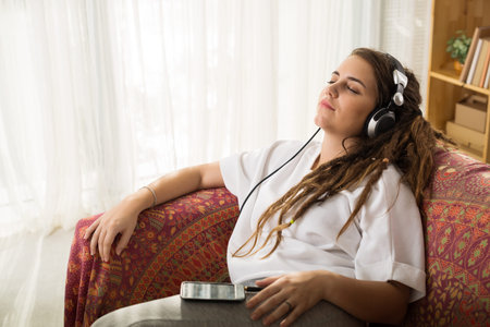 Pretty girl enjoying music on headphones