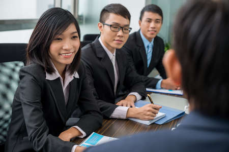 Asian business team having meeting with their chief in the officeの写真素材