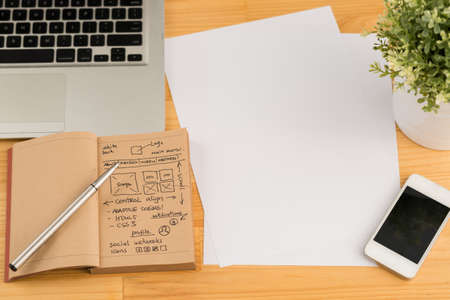 Blank sheets, smartphone, laptop and website development project on the tablet of designerの写真素材