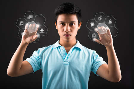 Teenager pushing digital buttons, futuristic technologyの写真素材