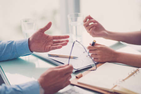Hands of business people discussing annual reportの写真素材
