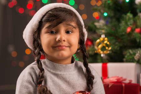 Portrait of adorable little girl in Santa Claus hatの写真素材