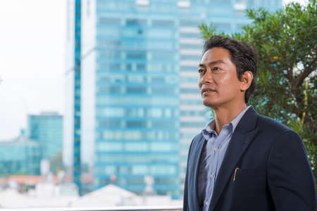 Portrait of middle-aged Vietnamese manager looking asideの写真素材