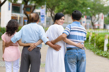 Rear view of embracing senior friends