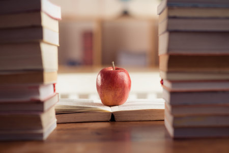 Red apple between book stacks as a symbol of wisdom