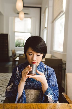Japanese woman enjoying matcha in the cafe