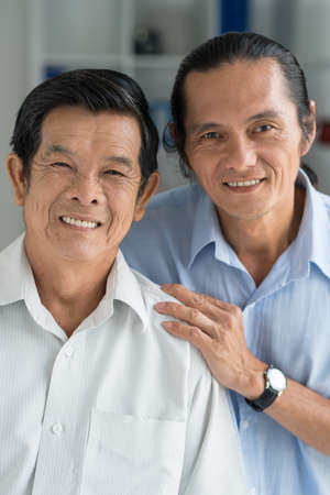 Portrait of Vietnamese senior man and his middle-aged sonの写真素材