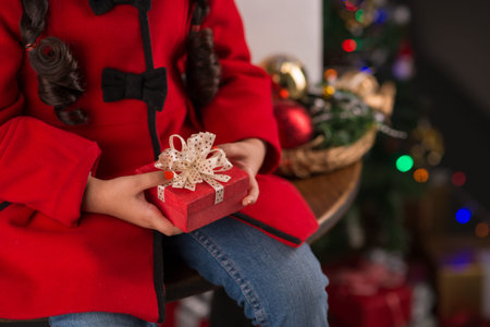 Cropped image of girl holding a small gift boxの写真素材