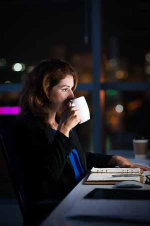 Late night office worker with a big mug of coffee