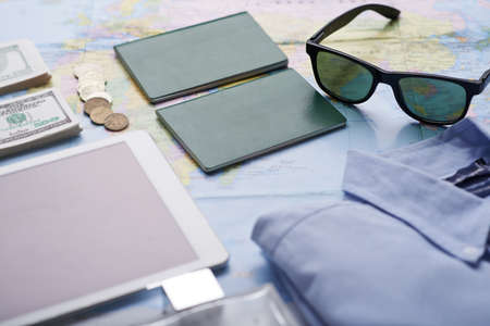 Everything for journey on the world map: documents, money, tablet and clothesの写真素材