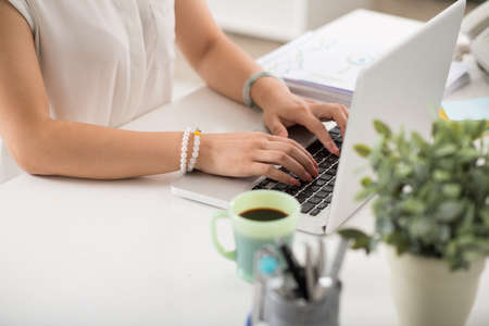 Hands of business lady typing on laptopの写真素材
