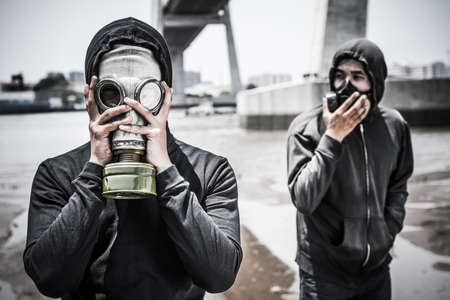 People in gas mask in the polluted cityの写真素材