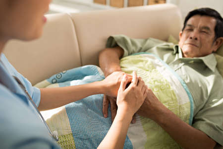 Doctor reassuring aged patient, selective focusの写真素材