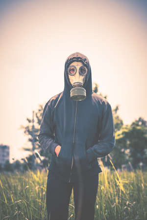Man wearing gas mask when walking outdoors: air pollution conceptの写真素材