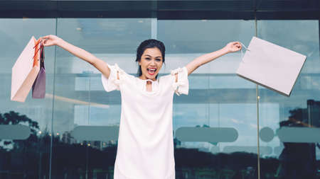 Happy excited woman with shopping bagsの写真素材