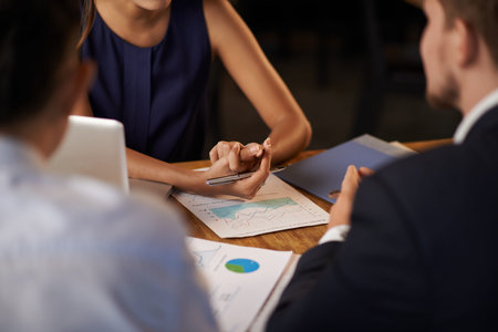 Hands of female entrepreneur explaining business objectives to her employeesの写真素材