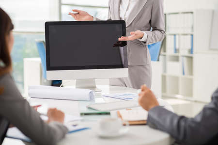 Cropped image of business lady using computer monitor when conducting presentationの写真素材