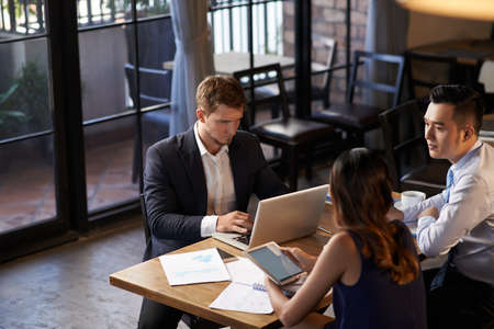 Business team working and talking in cafeの写真素材
