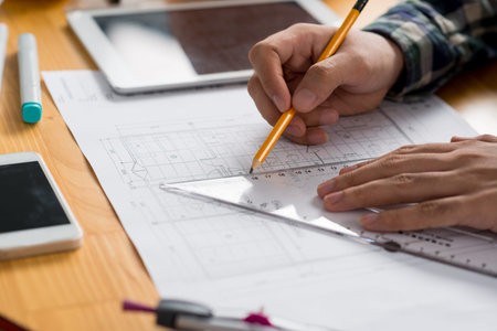 Hands of architect working on new project