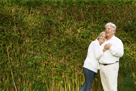 Mature couple in love standing in bamboo grooveの写真素材