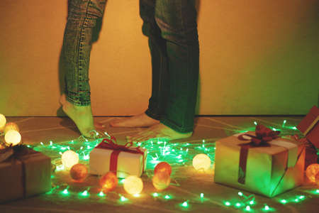 Legs of couple kissing after decorating home for Christmasの写真素材