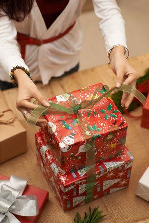Hands of woman wrapping Christmas presentsの写真素材