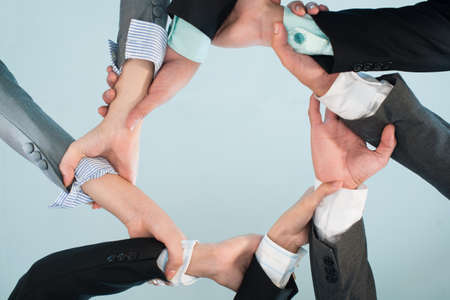 Ring from hands of business people as symbol of cooperationの写真素材