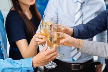Close-up image of business people clinking glassesの写真素材