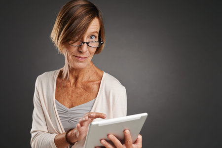 Portrait of mature woman using digital tabletの写真素材