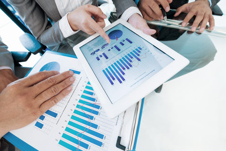 Close-up image of business executives discussing annual report