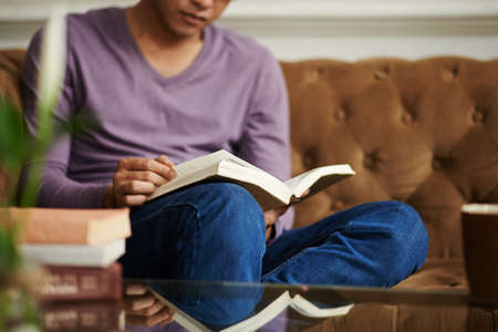 Man reading manual at home, selective focusの写真素材