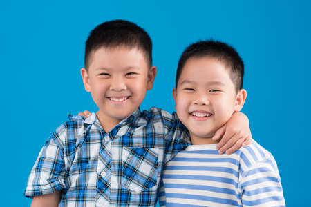 Happy Chinese boys smiling and looking at the cameraの写真素材
