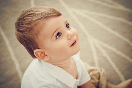 Face of adorable little kid looking upの写真素材