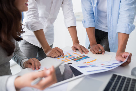 Cropped image of development team discussing interface of new application