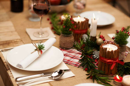 Decoration of Christmas table: candles, juniper branches and napkinsの写真素材
