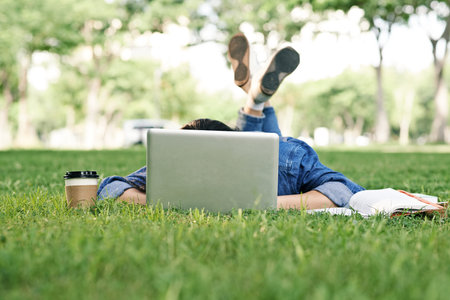 University student fell asleep when doing homework on campusの写真素材
