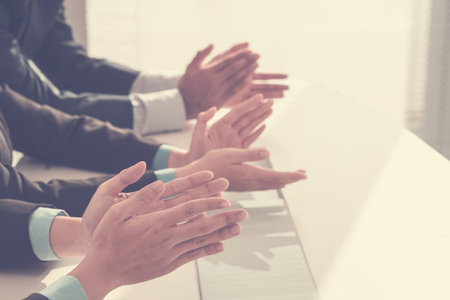 Row of clapping hands at business seminarの写真素材