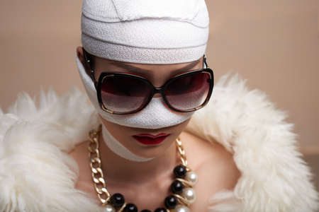 Glamorous woman in face bandage after plastic surgeryの写真素材