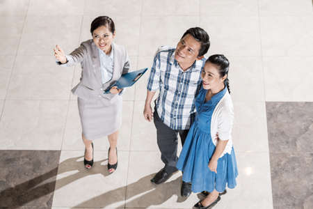 Pretty estate broker sowing house to Vietnamese married coupleの写真素材