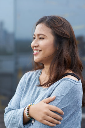 Portrait of happy Indonesian woman standing outdoorsの写真素材