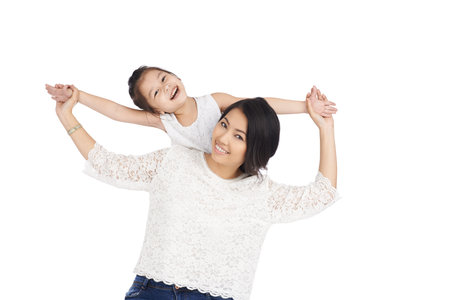 Happy beautiful woman having fun with her little daughterの写真素材