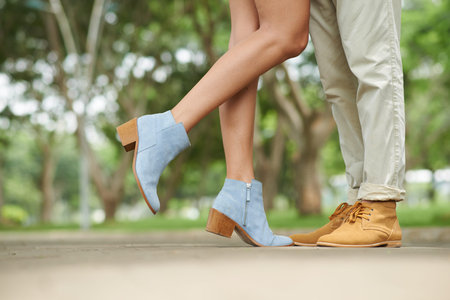 Legs of couple kissing in the park