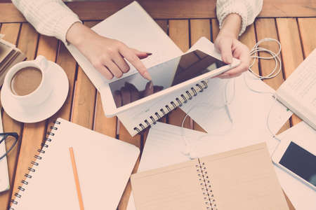 Hands of female writer using digital tablet, view from aboveの写真素材