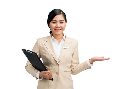 Smiling Asian business lady with folder in one hand and some product in anotherの写真素材