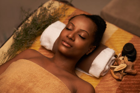 Beautiful woman fell asleep while having spa procedureの写真素材