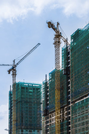Two cranes working on construction site